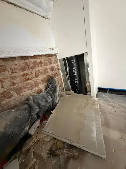 Exposed brick wall dried after water damage in Brooklyn