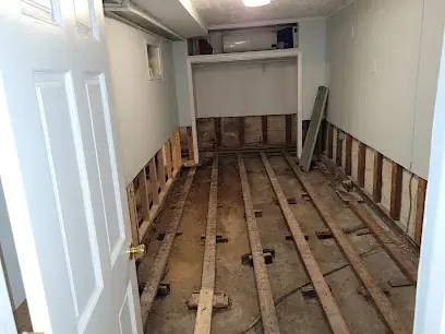 Water damaged floorboards pulled up in a Brooklyn hallway