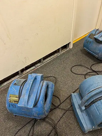 Air movers drying a water damaged Brooklyn room