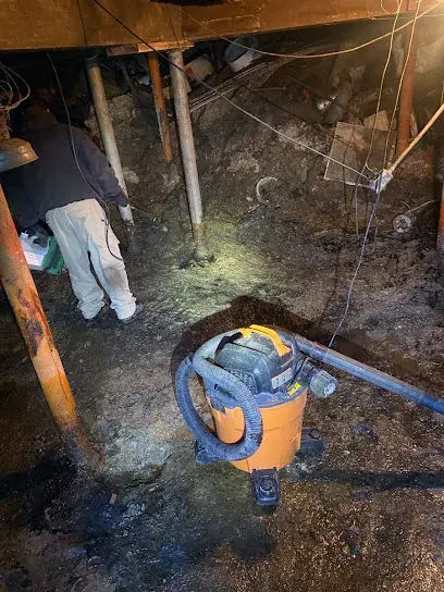 Technician extracting standing water from a Brooklyn floor